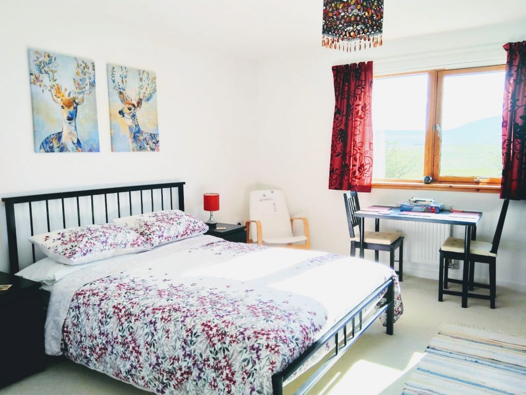 Staffin bed and breakfast bed, chair, table and view of Staffin Bay, The Quiraing, Trotternish Ridge Isle of Skye 